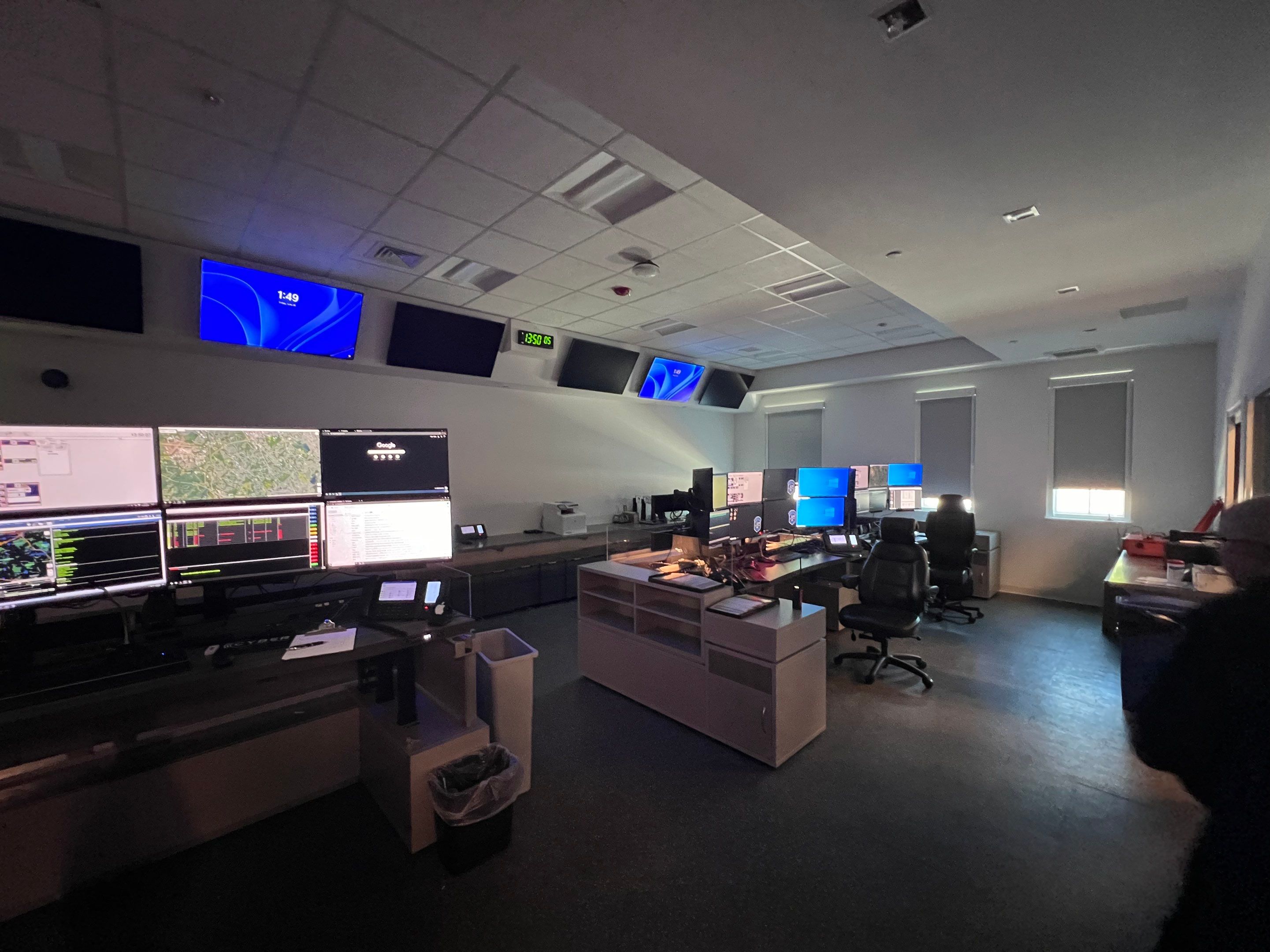 a room with many monitors and desks