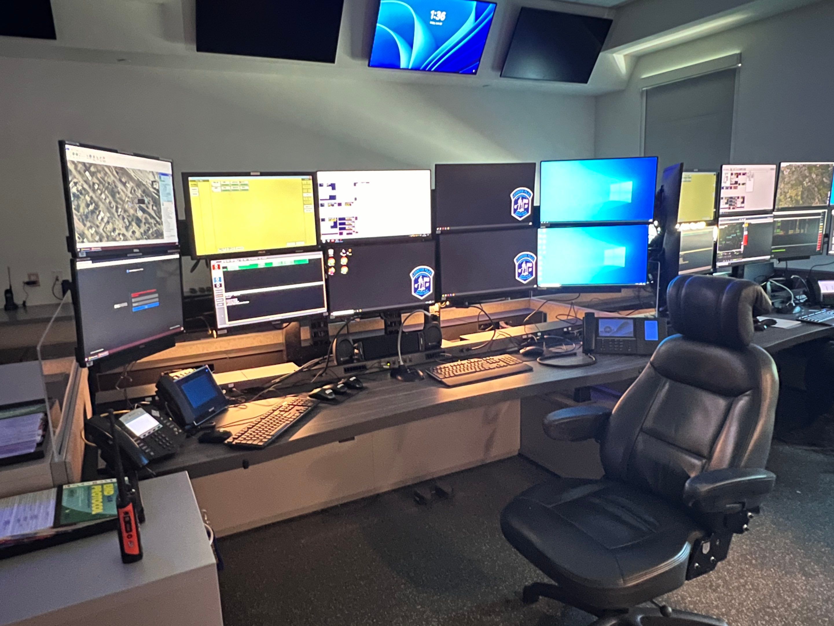a desk with ten monitors