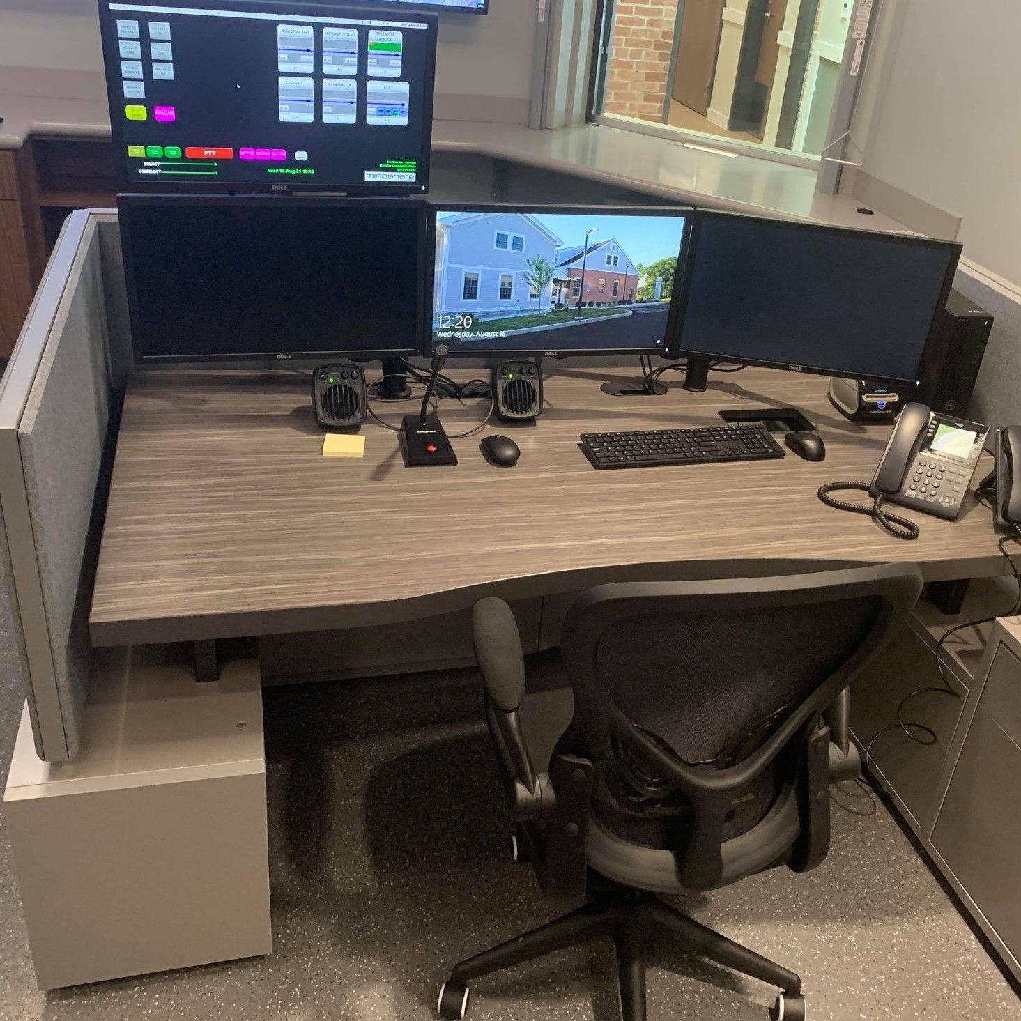 a desk with many monitors