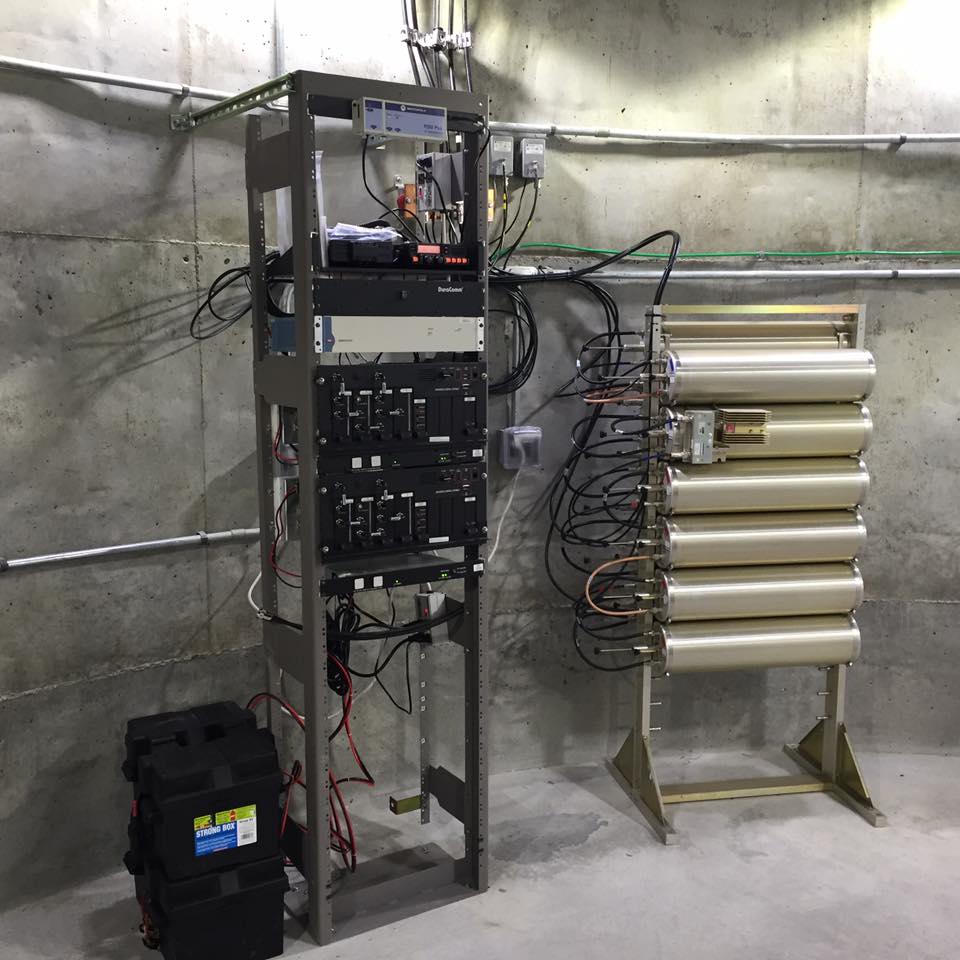 a tower of radio switches next to their power supplies